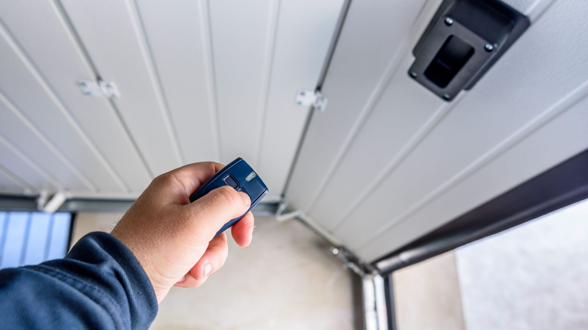 A person holding a remote control in their hand