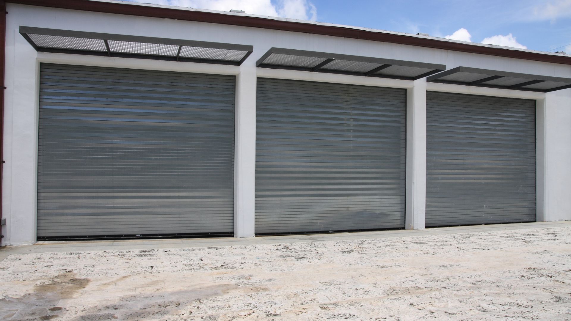 A row of closed garage doors in front of a building