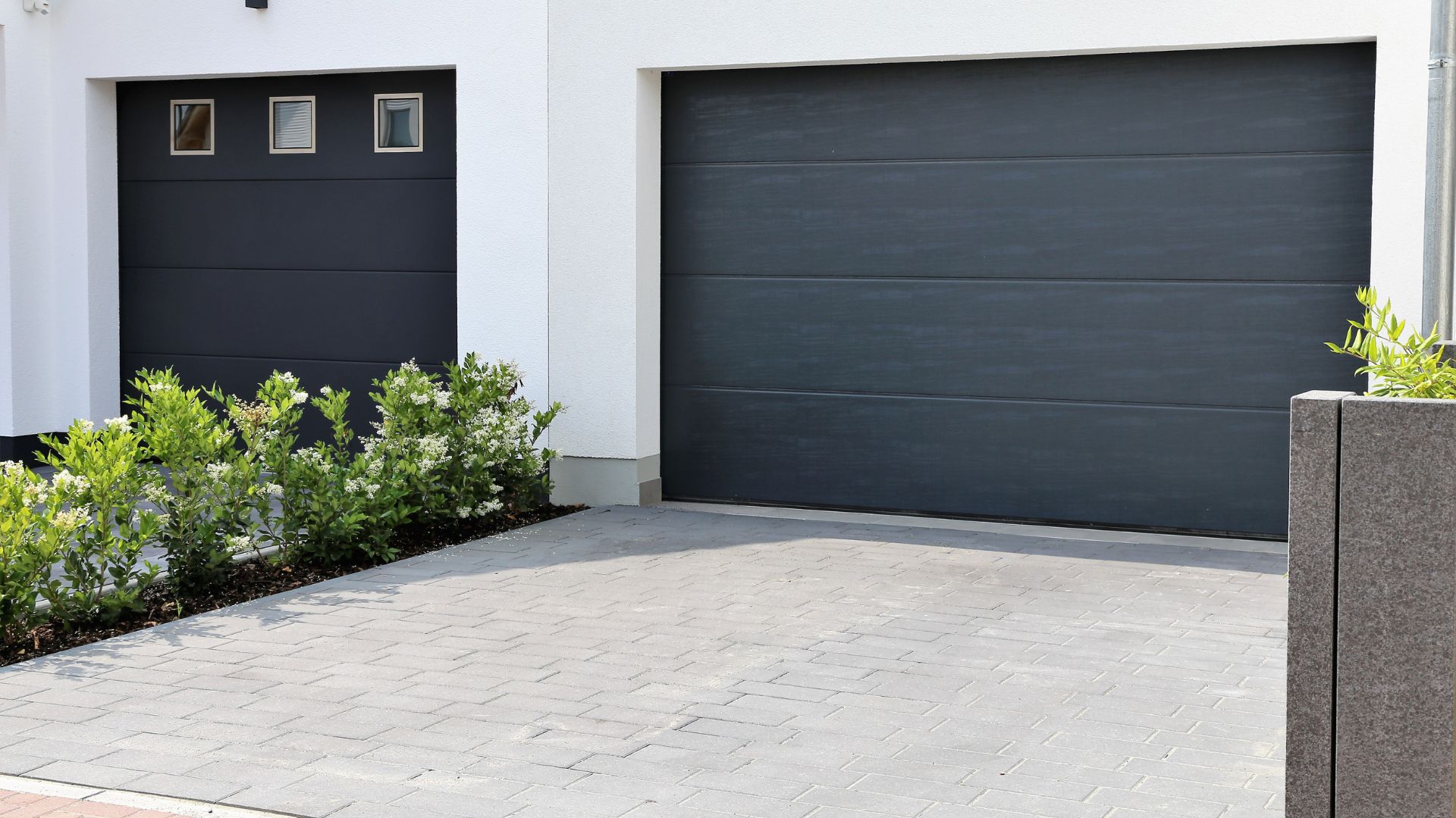 A white house with a black garage door